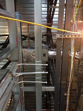Figure 2: A VAV box blocked by a wall header and low voltage cabling.