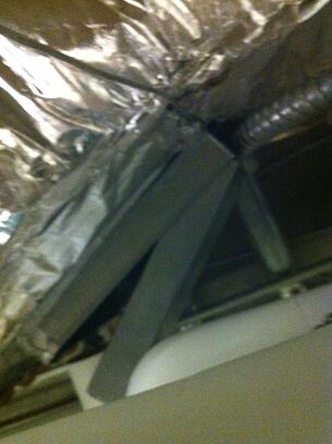 Figure 3: An access door upstream of a reheat coil blocked by piping and can't be fully opened.