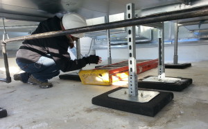A commissioning engineer inspects duct work.