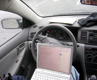 "Wardriving" - looking for unsecured networks. Photo by Flickr user groov3.