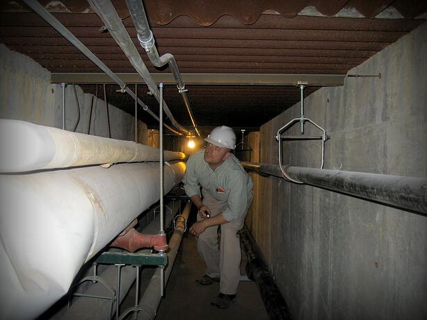 A commissioning agent inspects piping